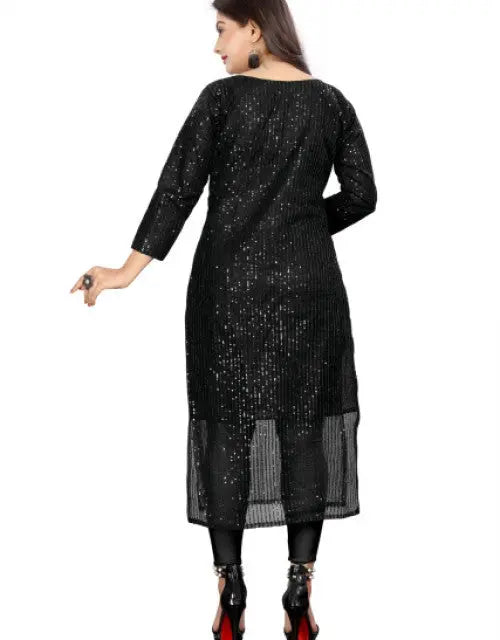Woman wearing a black sequined dress on a white background