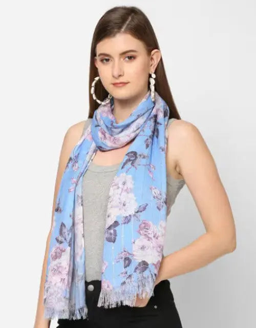 Woman wearing a blue floral scarf on a white background