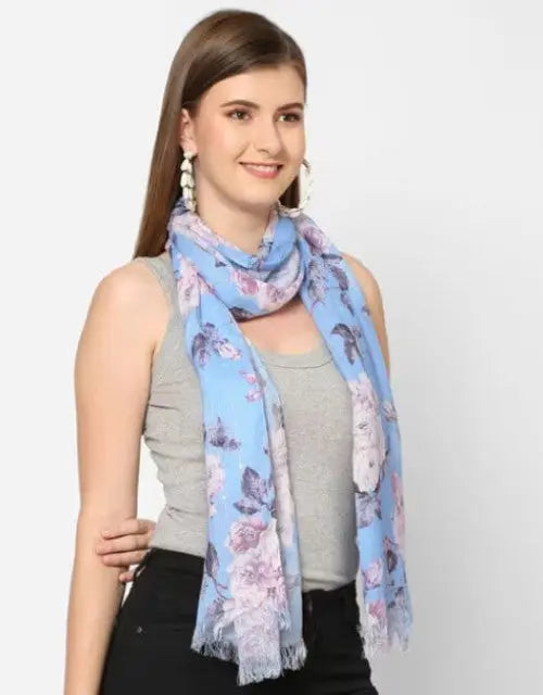 Woman wearing a light blue floral scarf on a white background