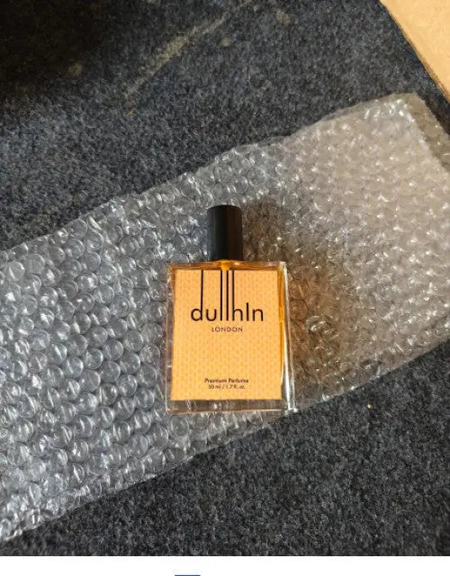 Dulln perfume bottle on bubble wrap with a dark background