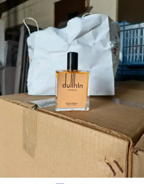 Dulhan perfume bottle on a cardboard box with a blurred background