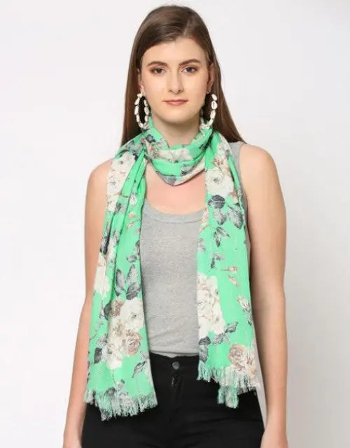 Woman wearing a green floral scarf on a white background
