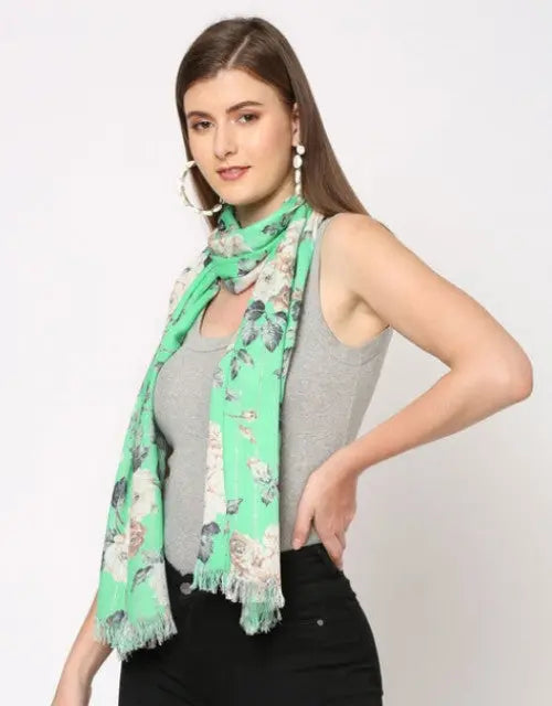 Woman wearing a green floral scarf on a white background