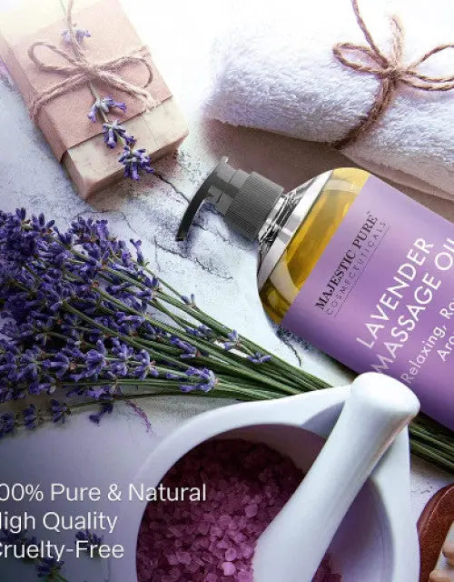 Lavender massage oil bottle with lavender flowers and a white bowl on a light background