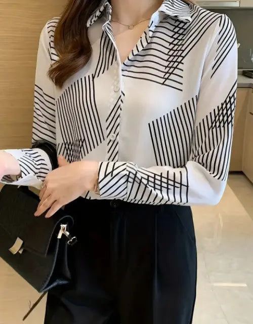 Person wearing a black and white striped shirt in an indoor setting