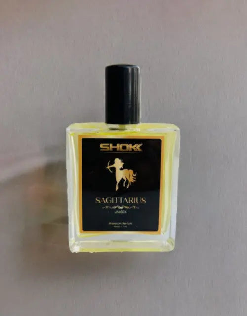 Perfume bottle labeled 'Shok Sagittarius' on a plain background

