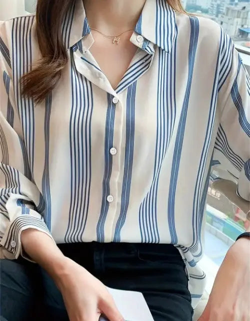Person wearing a striped shirt with a blurred background