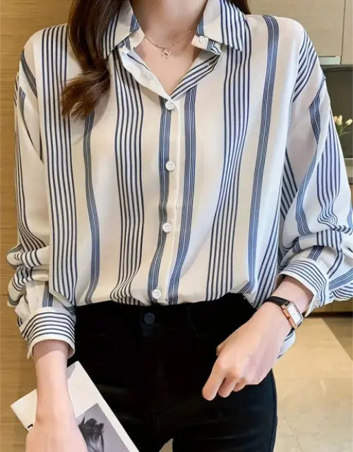 Person wearing a striped shirt with long sleeves in an indoor setting