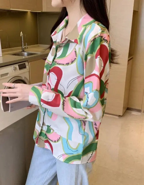 Person wearing a colorful patterned shirt in a kitchen
