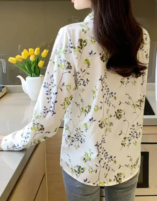 Person wearing a floral blouse in a kitchen setting