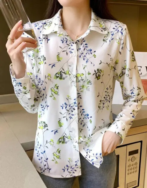 Person wearing a white floral shirt in an indoor setting