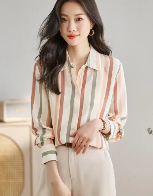Woman wearing a striped shirt with a blurred indoor background
