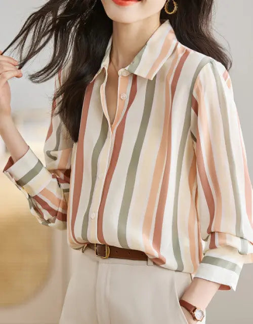 Person wearing a striped shirt with a blurred background