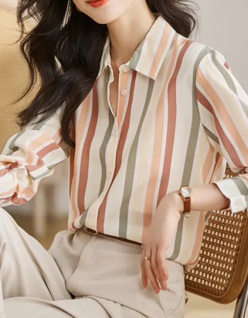 Woman wearing a striped shirt with a blurred background