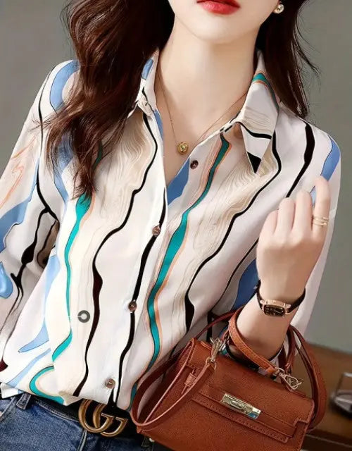 Woman wearing a patterned blouse with a brown handbag