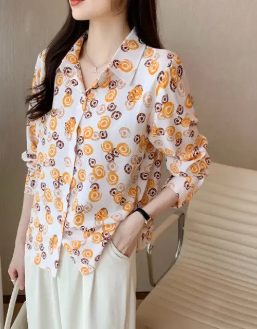 Woman wearing a floral blouse with a neutral background