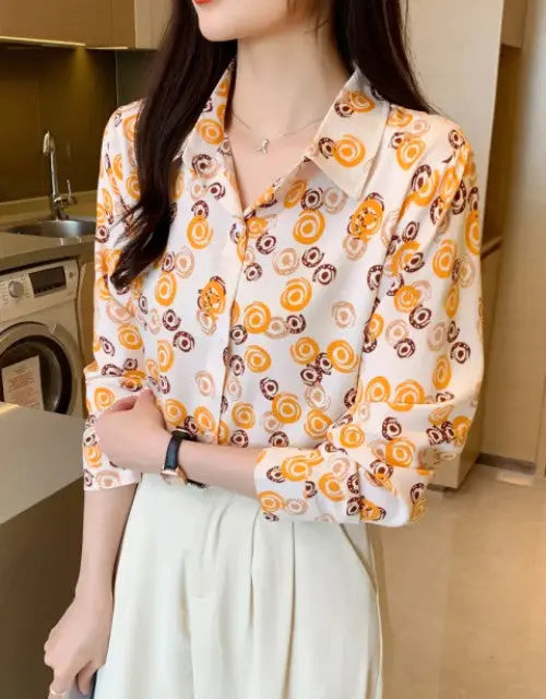 Person wearing a patterned shirt in a kitchen setting