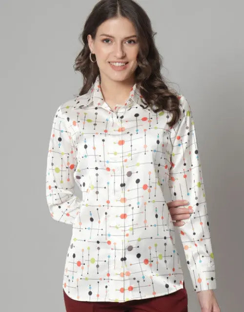Woman wearing a patterned shirt with colorful dots on a gray background