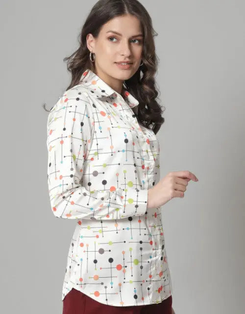 Woman wearing a patterned blouse against a gray background