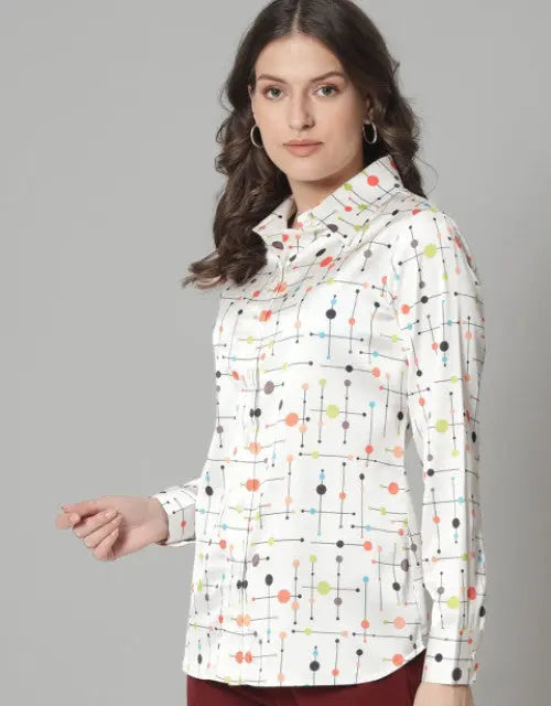 Woman wearing a white shirt with colorful dot pattern against a gray background