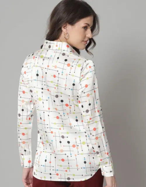 Woman wearing a white jacket with colorful geometric pattern on a gray background