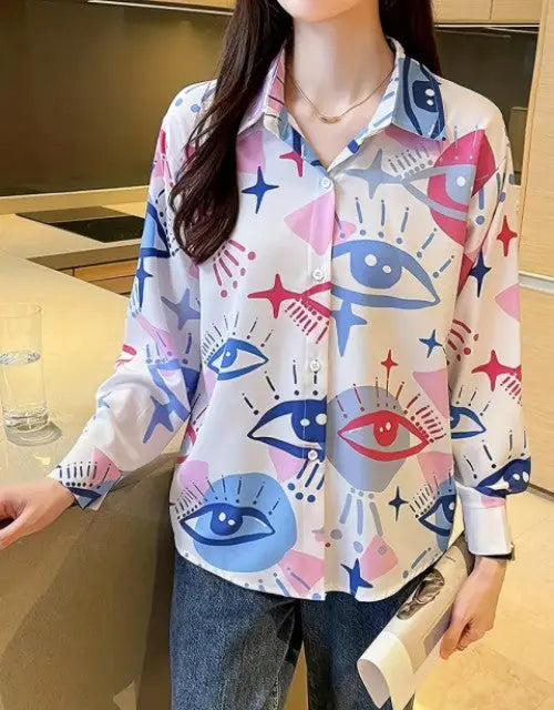 Person wearing a colorful shirt with abstract designs in a kitchen setting