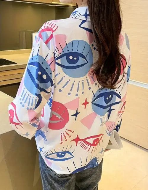 Person wearing a colorful shirt with abstract designs in a kitchen.