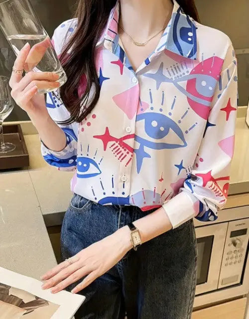 Person wearing a colorful patterned shirt in a kitchen setting